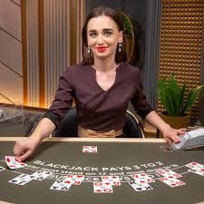 Studio kasino langsung tambak bet dengan dealer, meja, dan pemandangan multi-kamera dari permainan baccarat